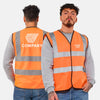 Person wearing an orange safety vest with 'COMPANY' and 'NAME TAG' text on a plain background